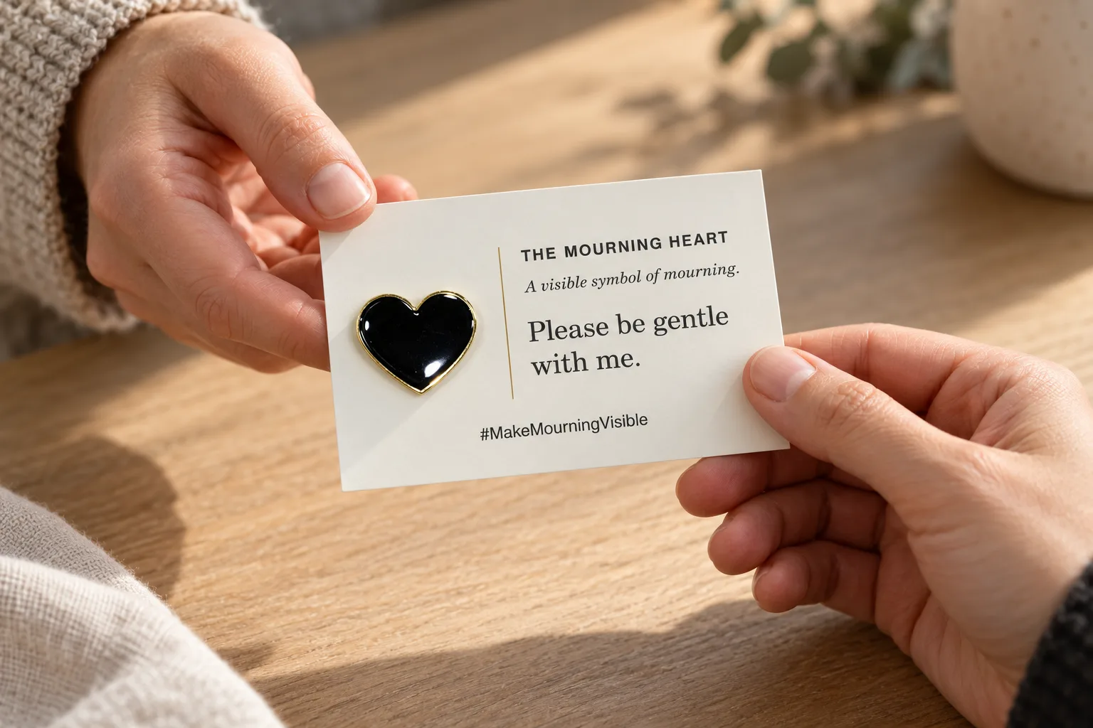 Two people sharing a Mourning Heart pin and its explanation card